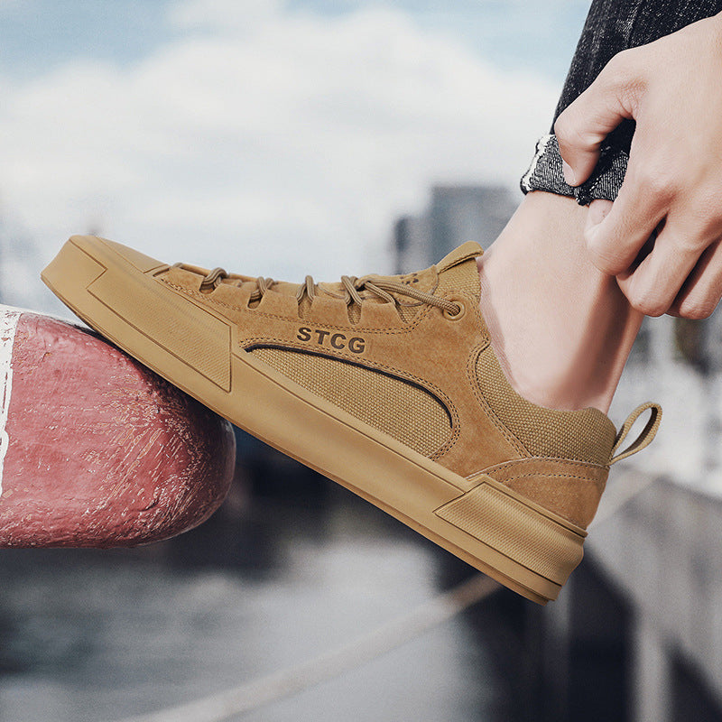 Brown sneaker with 'STCG' branding being worn, blurred cityscape background