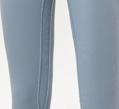 Close-up of light blue pants with white stitching on a white background