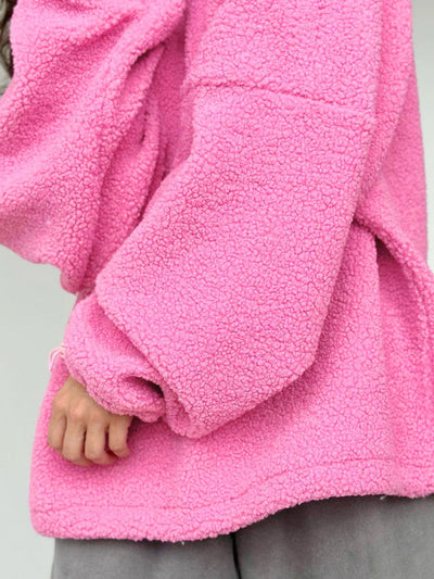 Close-up of a pink fleece jacket with a neutral background