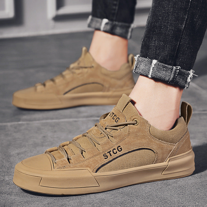 Brown sneakers with 'STCG' branding worn by a person on a gray pavement.