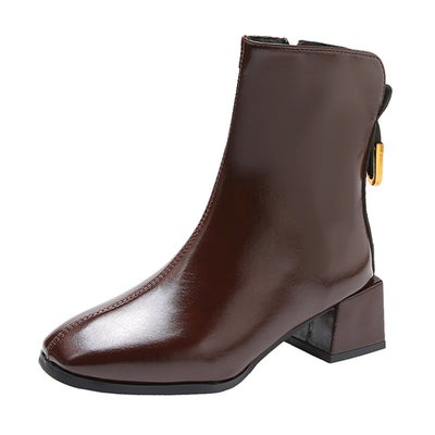 Brown ankle boot with a block heel on a white background