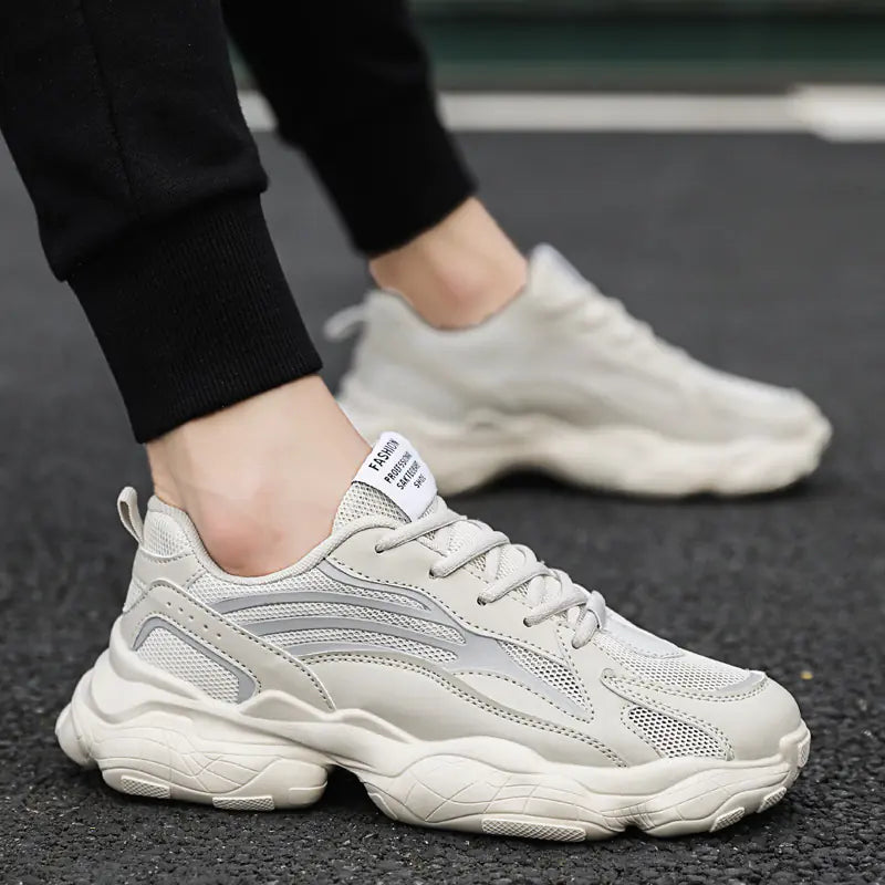 White sneakers worn on a dark asphalt surface