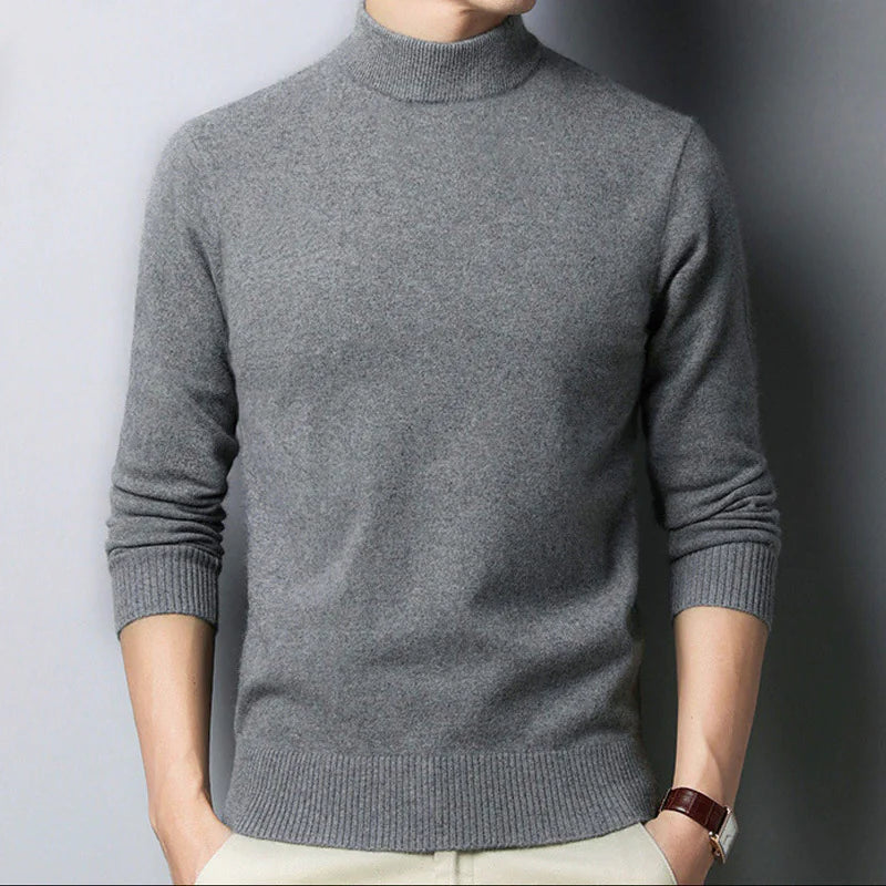 Gray turtleneck sweater worn by a person against a plain background