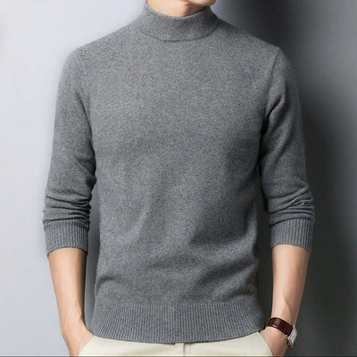 Gray turtleneck sweater worn by a person against a plain background