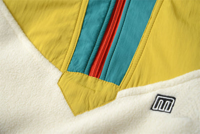 Close-up of a colorful fabric with a brand logo on a white background