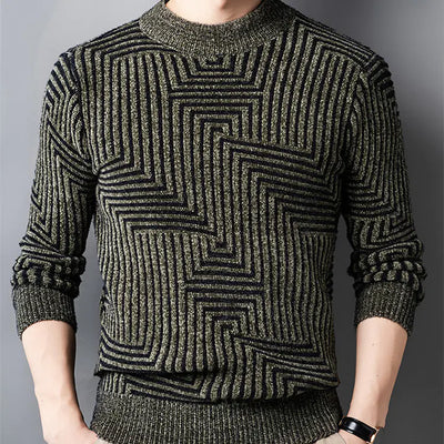Person wearing a green patterned sweater against a gray background