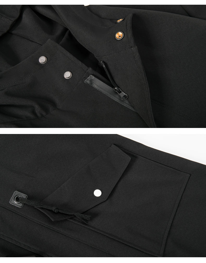 Close-up of a black jacket with buttons and zippers on a white background