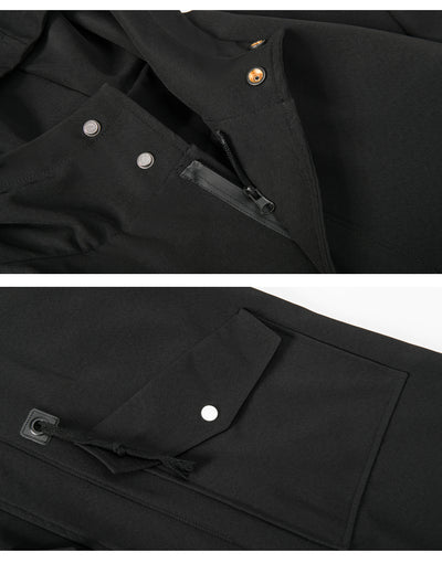 Close-up of a black jacket with buttons and zippers on a white background
