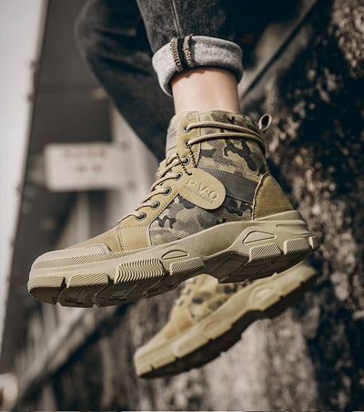 Camouflage tactical boots being worn with a blurred background