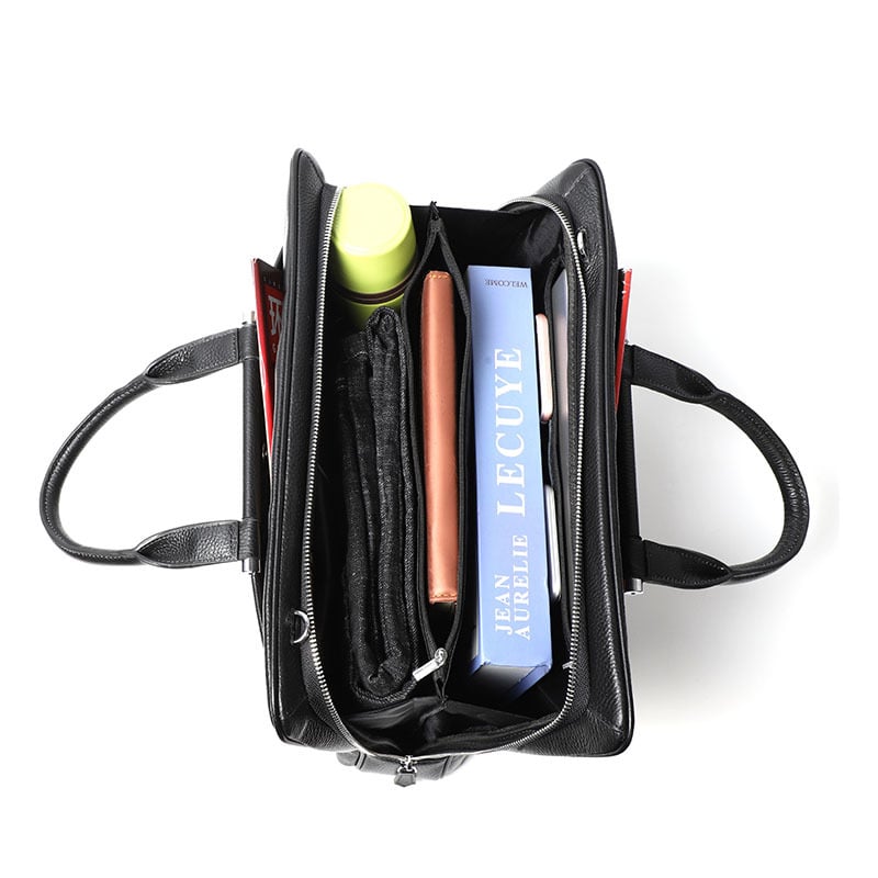 Black backpack with items including a bottle, book, and notebook on a white background