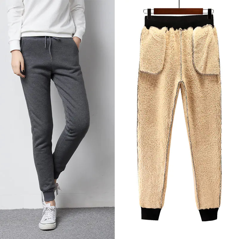 Two pairs of jogger pants, one gray and one beige with black cuffs, on a white background.