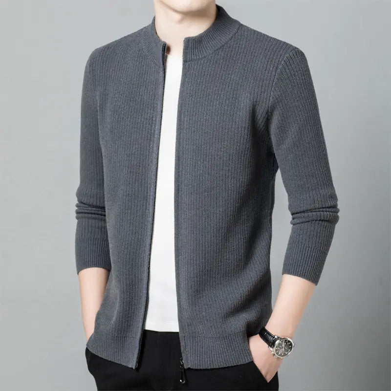 Gray knitted cardigan worn by a person on a gray background
