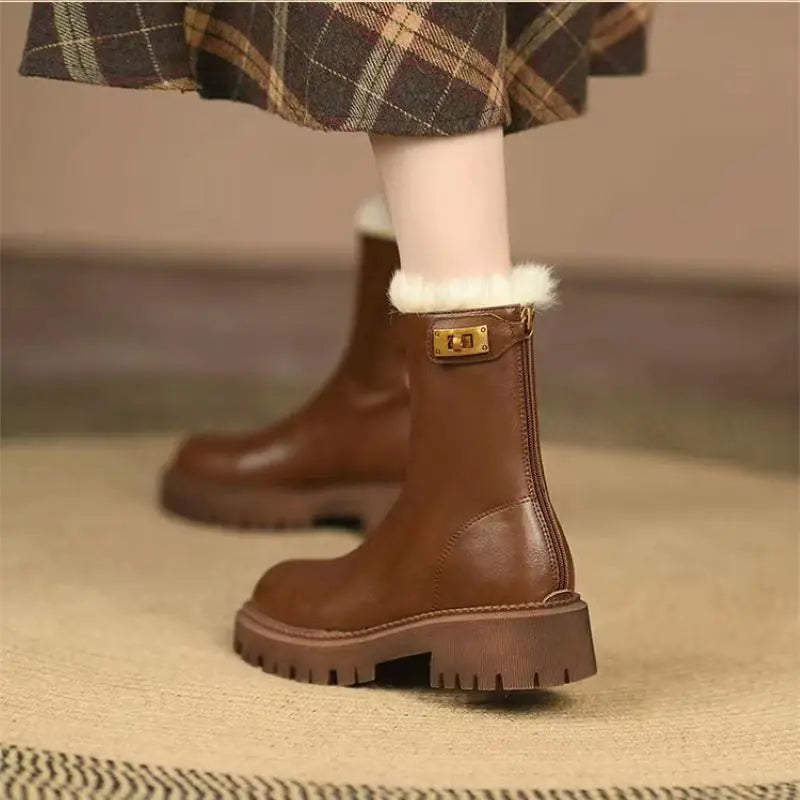 Brown leather boots with white fur lining worn by a person on a beige carpet.