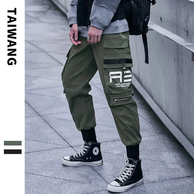 Person wearing green cargo pants with a logo and black high-top sneakers on a concrete floor.