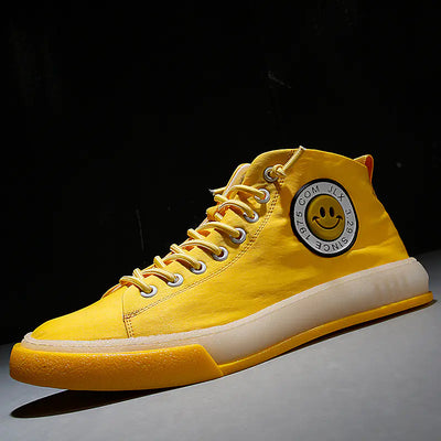 Yellow high-top sneaker with a smiley face logo on a dark background
