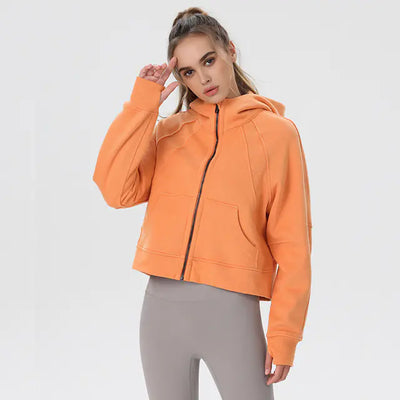 Woman wearing an orange hoodie on a white background