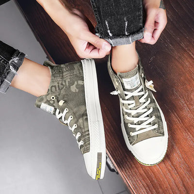Person wearing green high-top sneakers with white soles on a wooden floor.