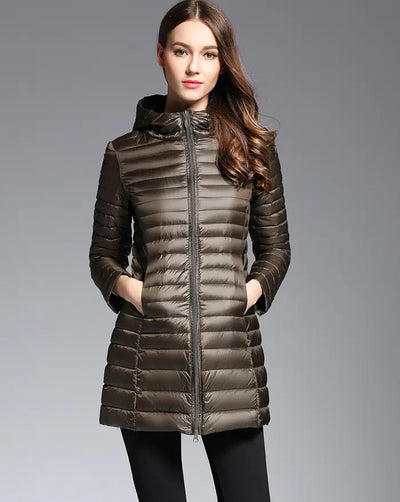 Woman wearing a brown puffer jacket on a gray background