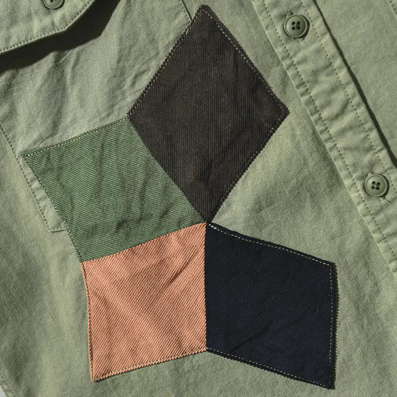 Close-up of a patchwork design on a green fabric surface