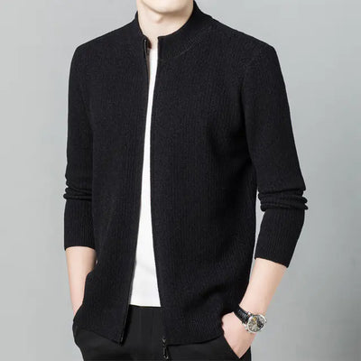 Black sweater worn by a person on a gray background