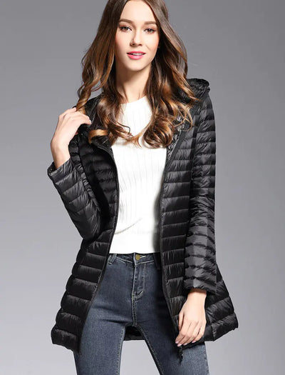 Woman wearing a black puffer coat on a gray background
