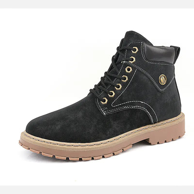 Black leather boot with tan sole on a white background