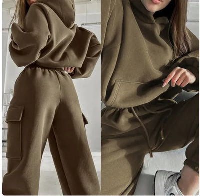 Brown hoodie and pants set worn by a person indoors.