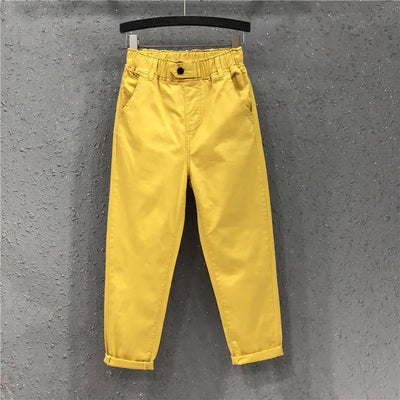 Yellow pants hanging on a gray textured wall