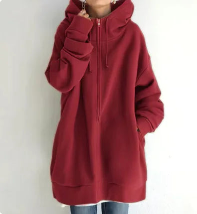 long Red hoodie worn by a person on a white background