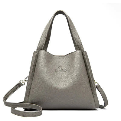 Gray handbag with a strap on a white background