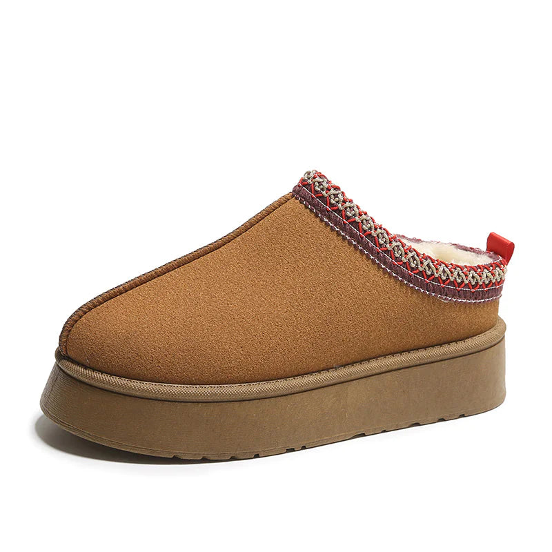Brown slipper with decorative trim on a white background